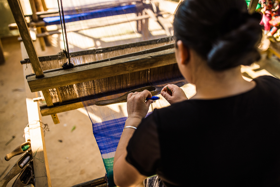 Ethnic Tai women weave textiles for their families and to sell to visitors.